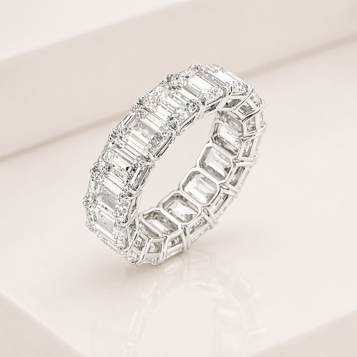 An emerald cut eternity band ring on a clean white background