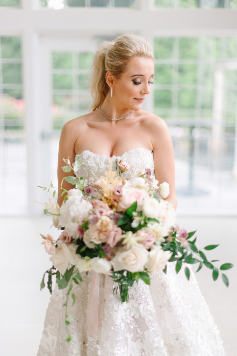 Bride holding flowers in indoor space