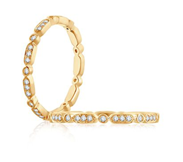 Yellow gold patterned anniversary band with round diamonds