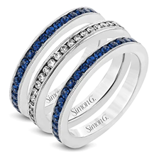 Stack of 3 white gold channel set anniversary bands, 2 with round sapphires and 1 with round diamonds