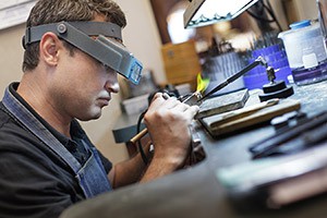 Jeweler working on a ring in our repair shop