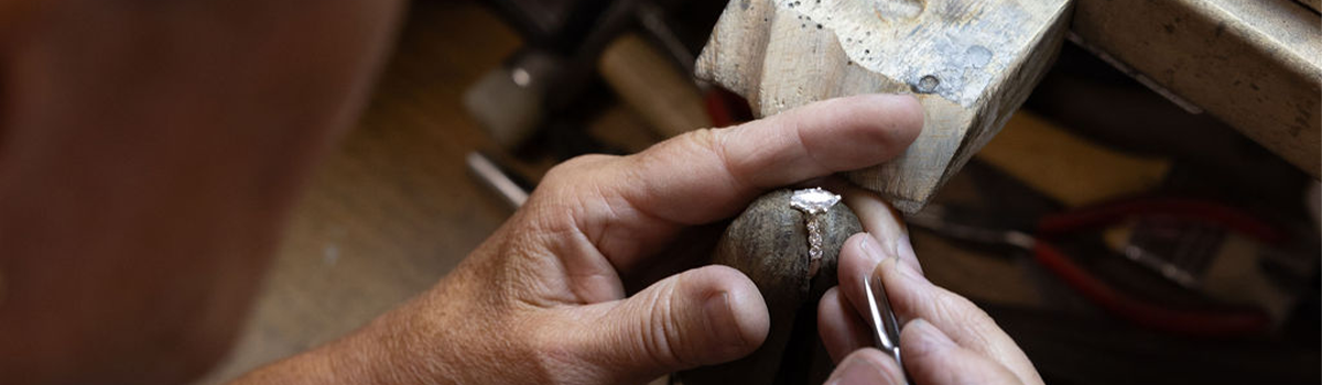 Jeweler working on a ring in our repair shop